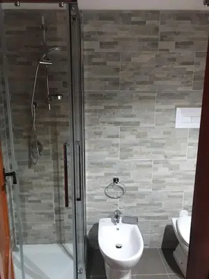 a bathroom with a shower and a toilet and a sink at La maison sul mare in San Vito lo Capo