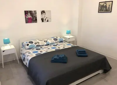 a bedroom with a bed with blue towels on it at Casa4Casa in Palermo
