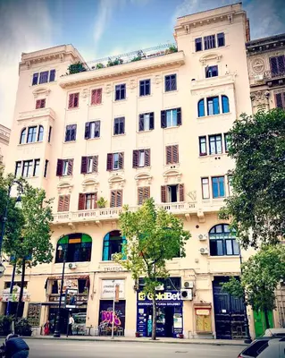 a large white building on the side of a street at Casa Ina Palermo in Palermo