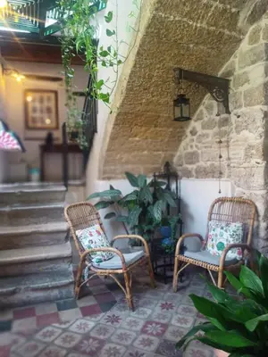 two wicker chairs sitting on a patio with stairs at Locanda Sette Fate SPA e Solarium in Palermo