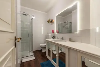 a bathroom with a sink and a shower and a toilet at Bouganville Home Mondello in Mondello