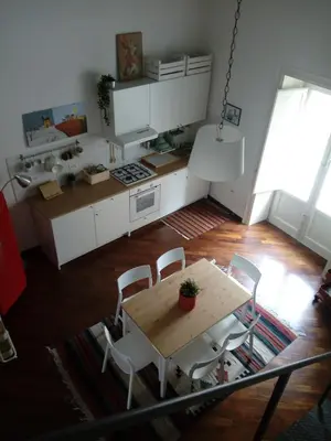 a kitchen with a table and chairs in a room at Casa Tea: nel cuore del centro storico in Palermo