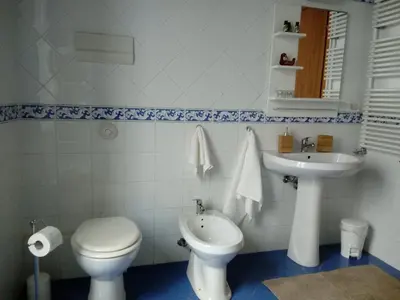 a white bathroom with a toilet and a sink at Casa Tea: nel cuore del centro storico in Palermo