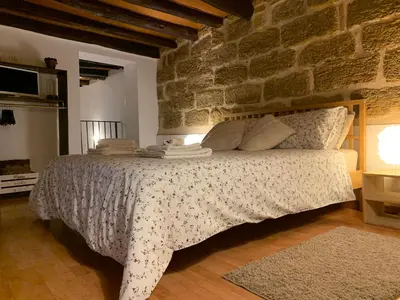 a bedroom with a bed in a brick wall at Casa Tea: nel cuore del centro storico in Palermo