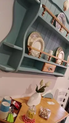 a room with a table with plates on shelves at La Rosa dei Venti in Isola delle Femmine