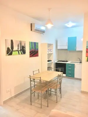 a kitchen and dining room with a table and chairs at ArtHouse in San Vito lo Capo