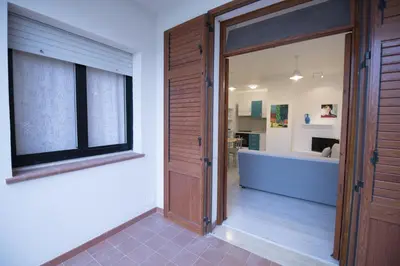 a hallway with a sliding door and a bathroom at ArtHouse in San Vito lo Capo