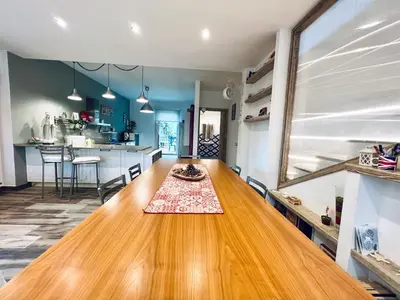 a kitchen and dining room with a wooden table at Casa di Ivana in Carini