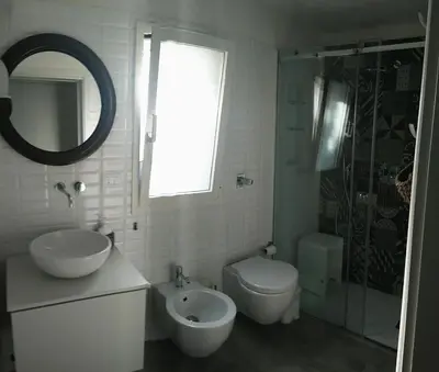 a bathroom with a sink and a toilet and a shower at Casa Calendule in Alcamo Marina