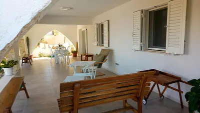 a room with a bench and a table and chairs at Casa Calendule in Alcamo Marina