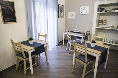 a dining room with two tables and chairs at Kalatfimi b&b in Palermo