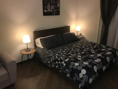 a bedroom with a bed with two lamps on two tables at Kalatfimi b&b in Palermo