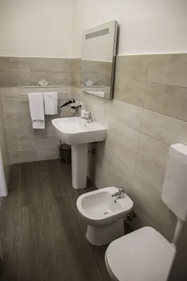 a bathroom with a sink and a toilet at Kalatfimi b&b in Palermo