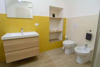 a bathroom with a sink and a toilet at Ficodì apartments in Alcamo