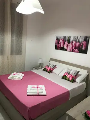 a bedroom with a large bed with two towels on it at Casa Rosita in San Vito lo Capo