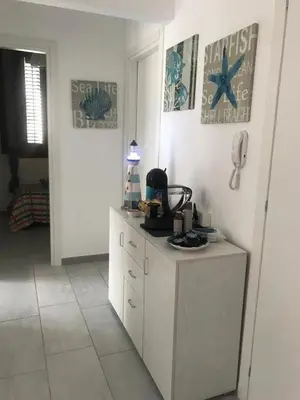a white kitchen with a counter and a starfish on the wall at Casa Rosita in San Vito lo Capo