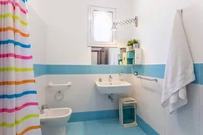 a bathroom with a sink and a toilet at Appartamenti Karma vacanze in Castelluzzo