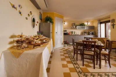 a kitchen and dining room with a table with food on it at Casa Manzella in Terrasini