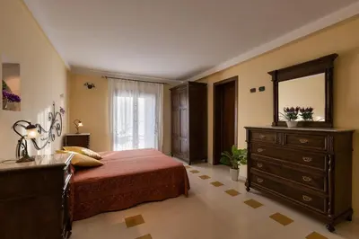 a bedroom with a bed and a dresser and a mirror at Casa Manzella in Terrasini