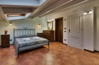 a bedroom with a bed and a dresser and a door at Casa Manzella in Terrasini