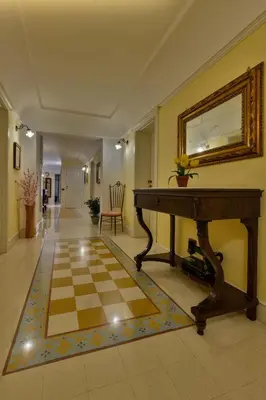 a room with a checkerboard floor and a mirror at Casa Manzella in Terrasini