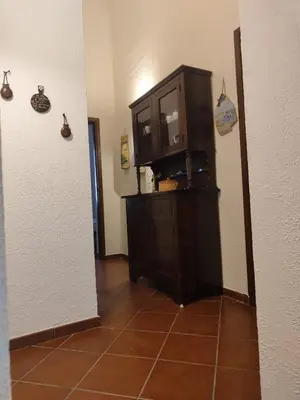 a kitchen with a cabinet and a tiled floor at Marina in Castellammare del Golfo