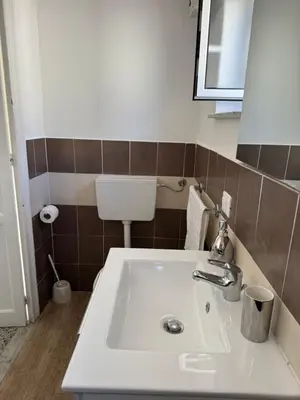 a bathroom with a white sink and a toilet at Holiday mondello martina in Mondello
