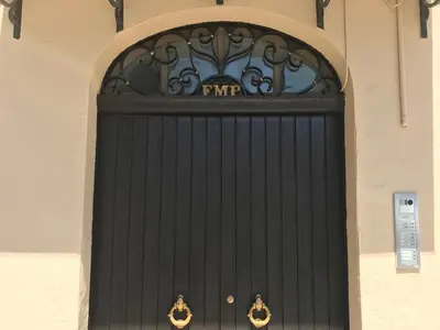 a black door with a sign on top of it at Frank's house - appartamento con terrazzo in centro in Palermo