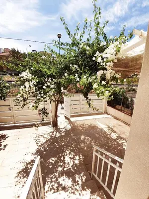 a tree with white flowers in a yard at Castellammare Holiday in Alcamo Marina