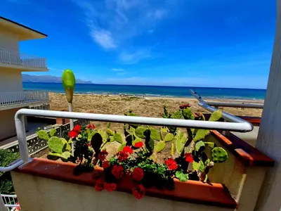 a planter with flowers on a balcony overlooking the beach at Castellammare Holiday in Alcamo Marina