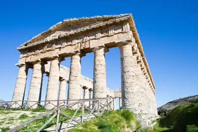 an ancient building with columns on top of a hill at Castellammare Holiday in Alcamo Marina