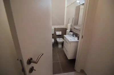 a small bathroom with a toilet and a sink at Via Vittorio Emanuele Apartment in Palermo