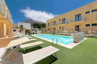 a resort with a swimming pool and a building at Residence Le Piscine in San Vito lo Capo