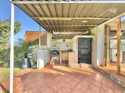 an outdoor patio with a grill and a fireplace at Villa Cocus in Altavilla Milicia