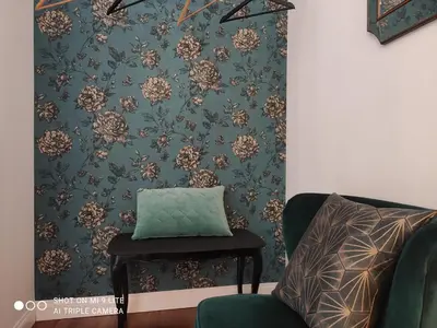 a room with a chair and a pillow on a wall at Il Rosone Luxury B&B in Palermo