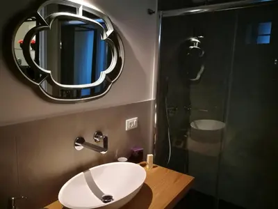 a bathroom with a sink and a mirror at Il Rosone Luxury B&B in Palermo