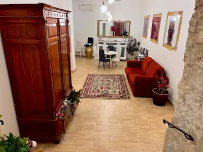 a room with a wooden cabinet next to a lamp at Palazzo delle Logge in Palermo