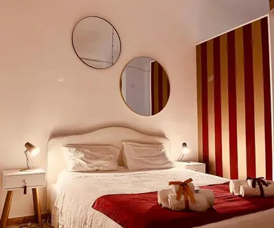 a bedroom with a bed with two mirrors on the wall at Palazzo delle Logge in Palermo