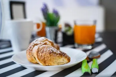 a white plate with a pastry on a table at Le Due Sicilie B&B in Lascari