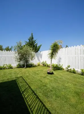 a yard with a fence and a palm tree at Arricàmpati Apartments Villa & Bringo Car Rental in Carini