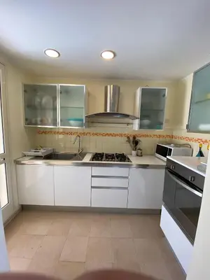 a kitchen with white cabinets and a sink at Appartamento casa mare in Alcamo Marina