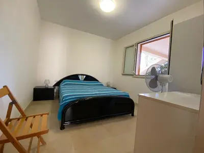 a bedroom with a bed in a room with a window at Appartamento casa mare in Alcamo Marina