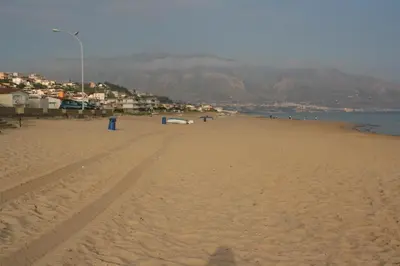 a beach with a car parked on the sand at Appartamento casa mare in Alcamo Marina