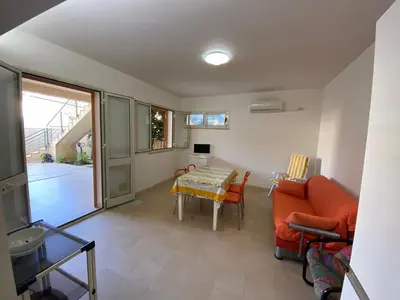 a living room with a couch and a table at Appartamento casa mare in Alcamo Marina