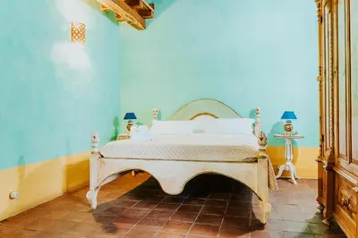 a bedroom with a bed in a blue wall at Terre Di Himera in Buonfornello