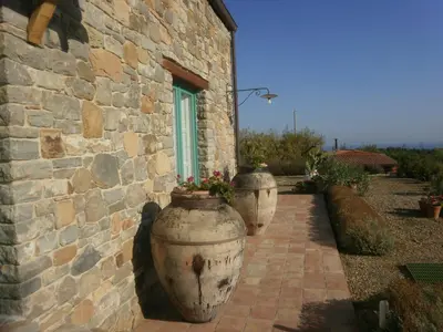 two large vases sitting outside of a stone building at Terre Di Himera in Buonfornello