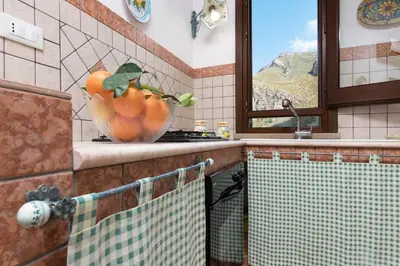a kitchen with a bowl of oranges on the counter at Appartamenti Irene in Macari