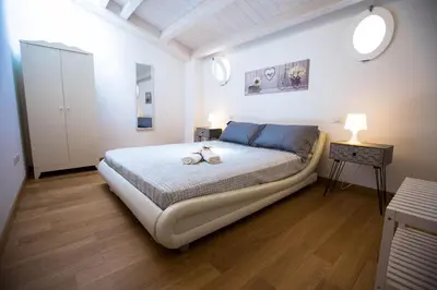 a bedroom with a bed with two shoes on it at Sciabika Home - Edificio Egadi in Castellammare del Golfo