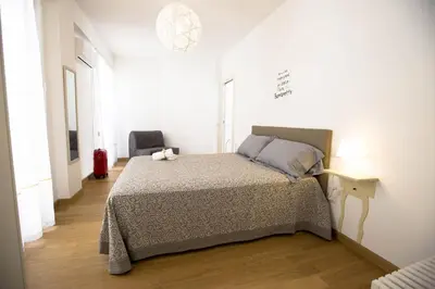a bedroom with a bed in a white room at Sciabika Home - Edificio Egadi in Castellammare del Golfo