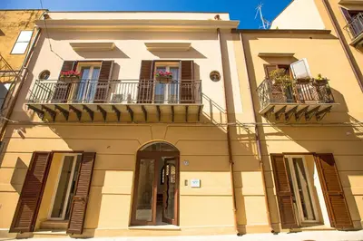 a building with two balconies and a door at Sciabika Home - Edificio Egadi in Castellammare del Golfo